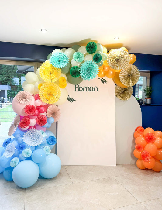 Mise en situation dans une arche de ballons de la rosace en papier jaune à suspendre ajourée