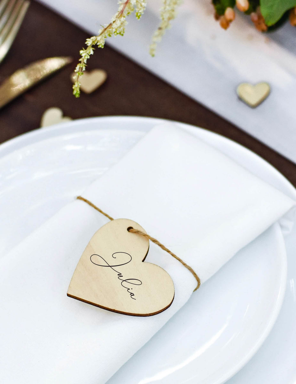 Staging on a table of the heart place card in natural wood with string