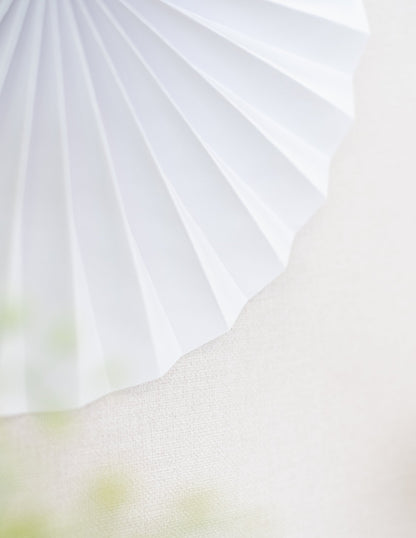 Gros plan sur les plis en accordéon du lot de 5 rosaces en papier de décoration pour fête blanches