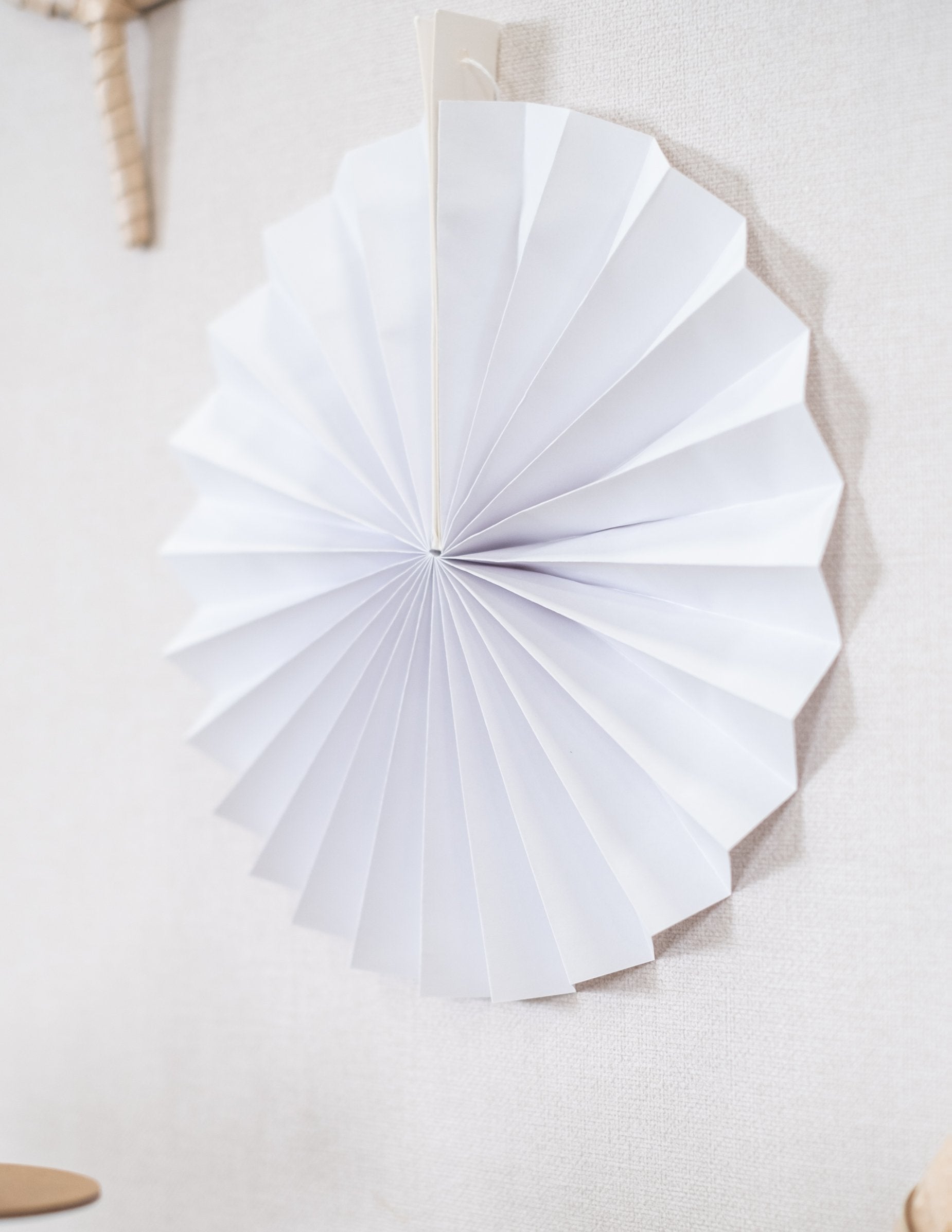 Vue de profil d'une rosace du lot de 5 rosaces en papier de décoration pour fête blanches