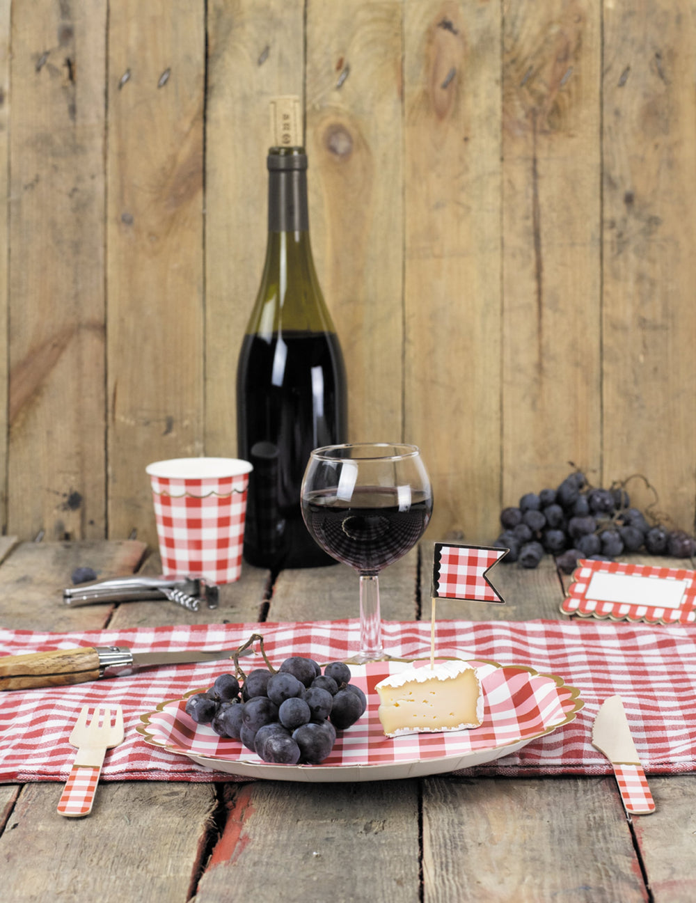 Mise en situation sur une table des fourchettes en bois vichy pour fête rouge et doré