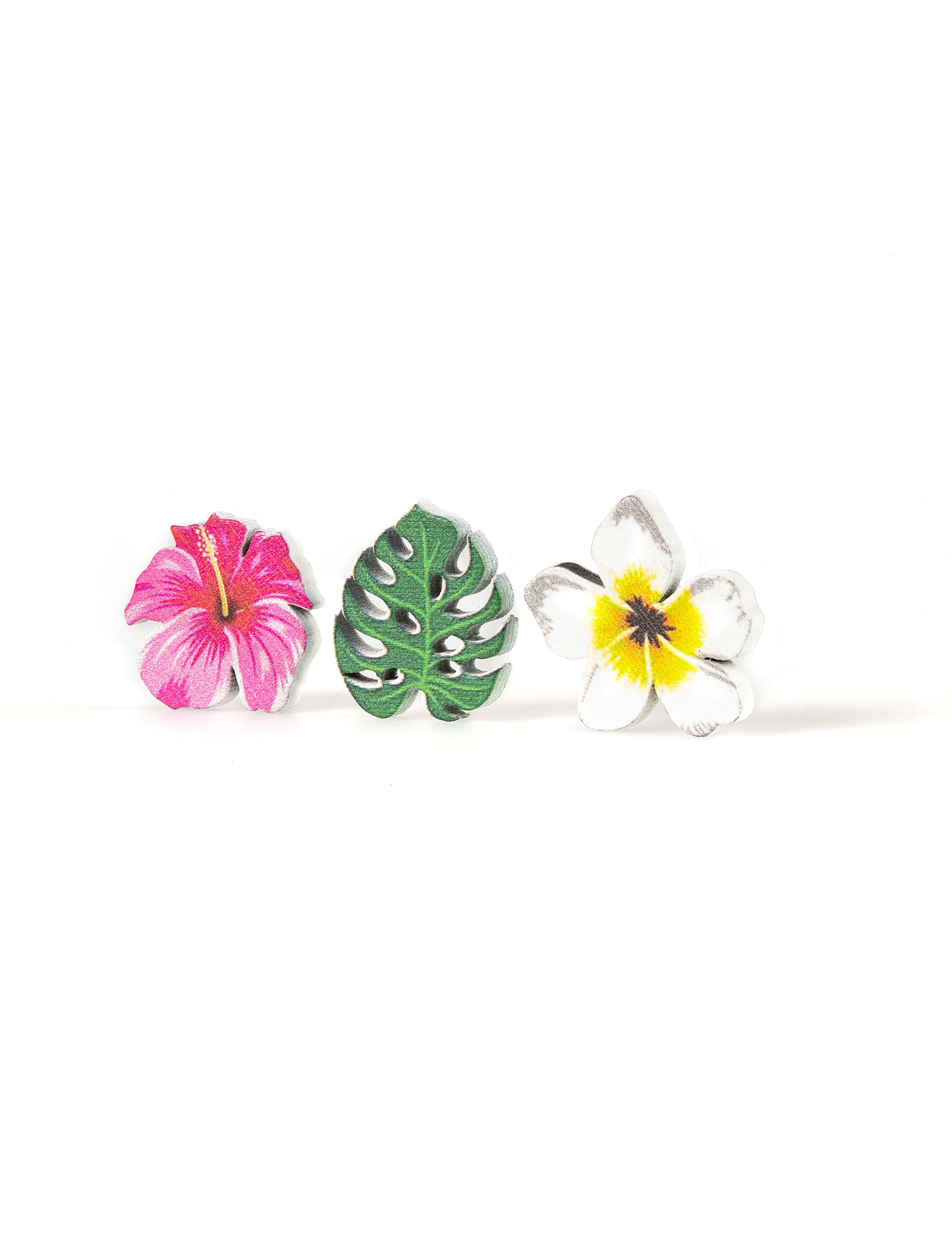 Gros plan sur les trois motifs des confettis en bois fleurs et feuilles tropicales