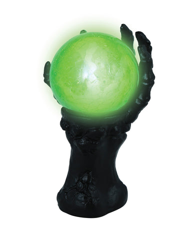 Černá kostlivá ruka se světélkující křišťálovou koulí