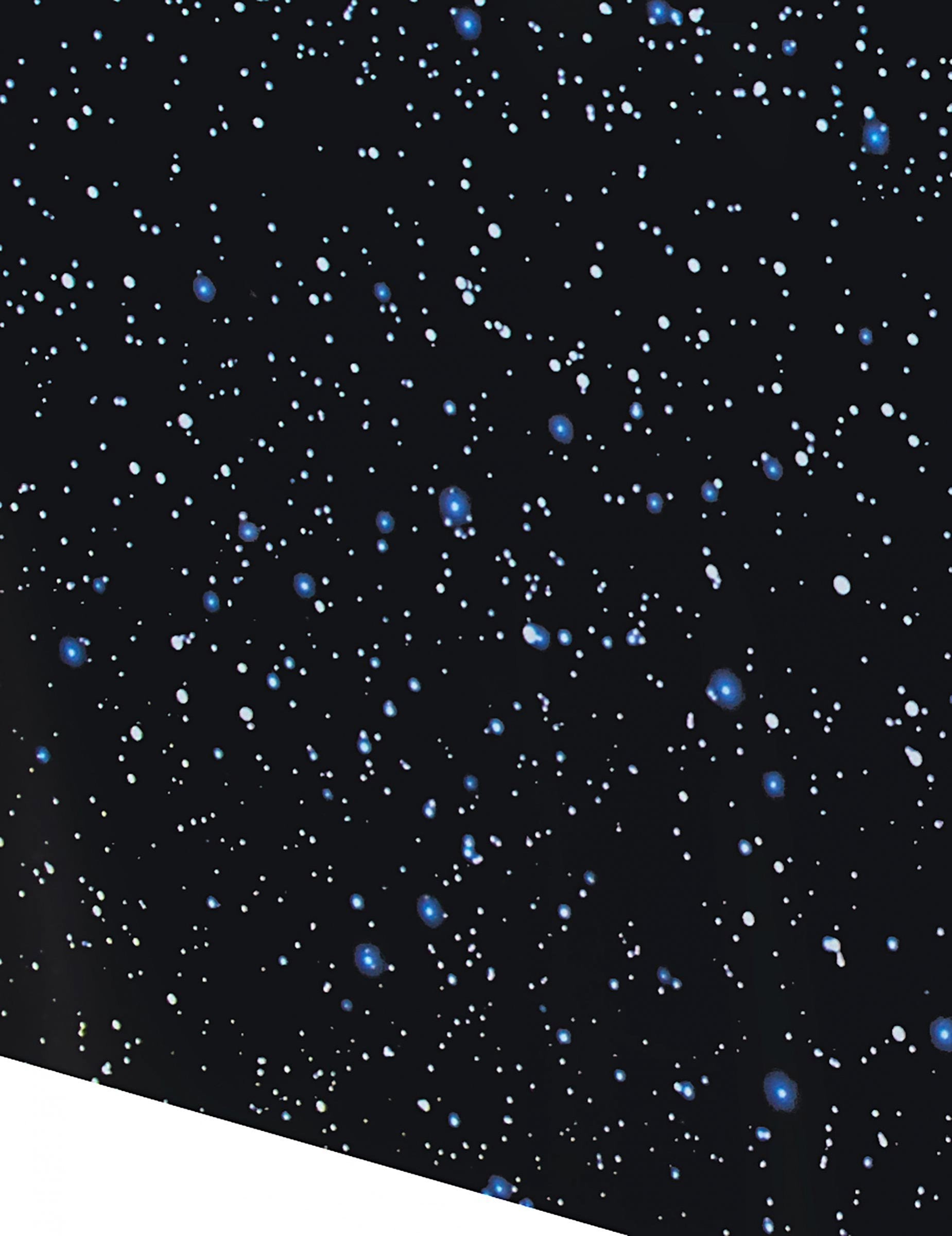 Detail hvězdného vzoru plastového ubrusu na oslavu narozenin ve vesmíru