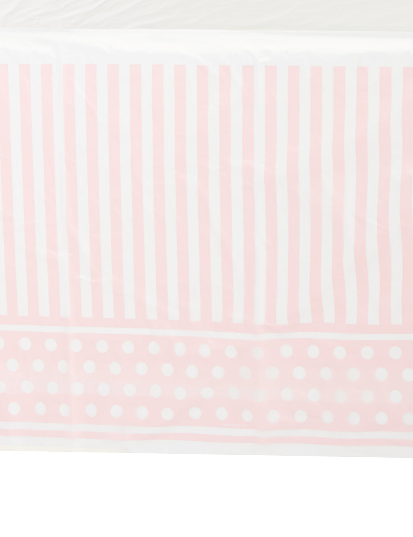 Détail du motif de la nappe en plastique rayé et à pois rose et blanc