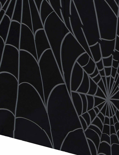 Détail du motif de la nappe en papier toiles d'araignées